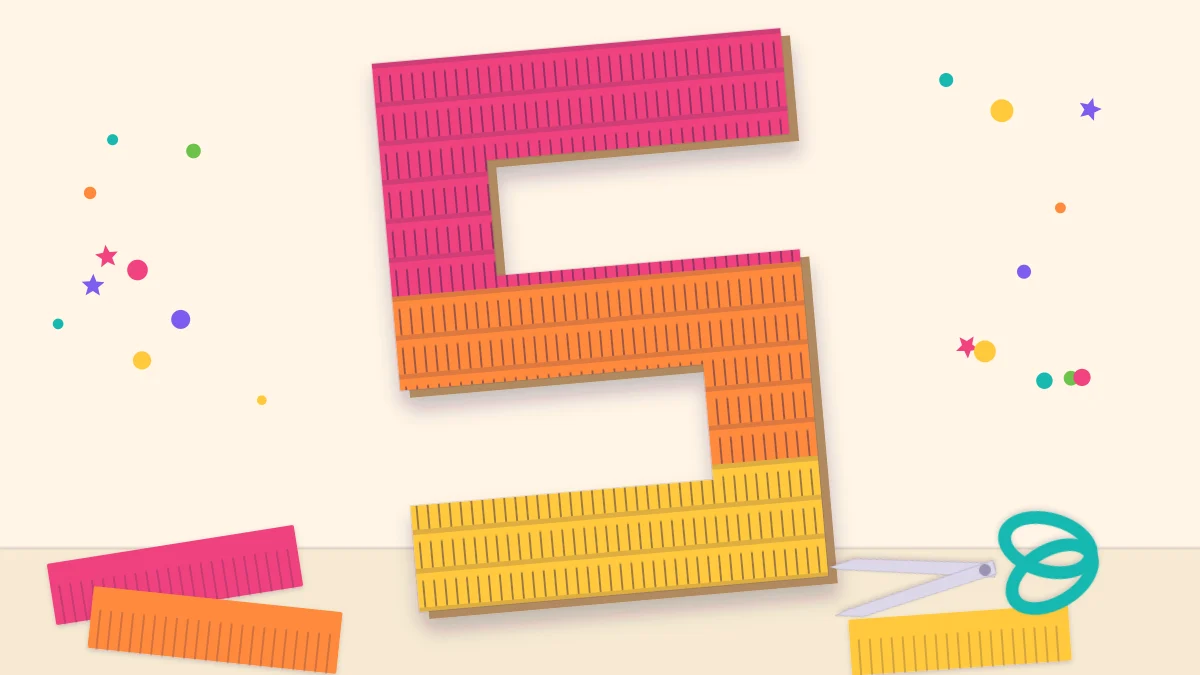A giant cardboard number five covered in rows of pink, orange and yellow tissue paper fringe