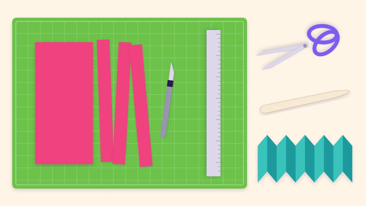 Scissors, a metal ruler, a craft knife and a bone folder beside cut cardstock strips and an accordion-folded strip
